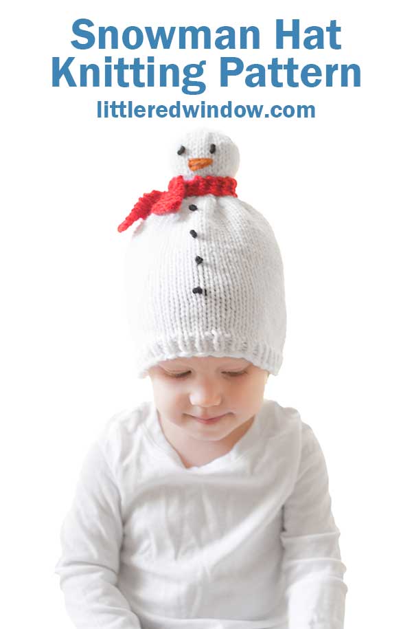 A baby in a knitted snowman hat, complete with a red scarf and black button details, gazes sweetly in a white shirt against a white backdrop. Text above reads
