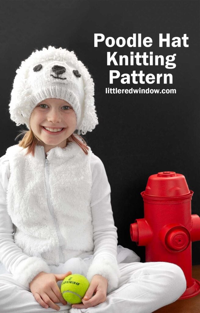 A child wearing a fluffy white hat resembling a poodle smiles while sitting next to a red fire hydrant. They are holding a tennis ball. Text reads,