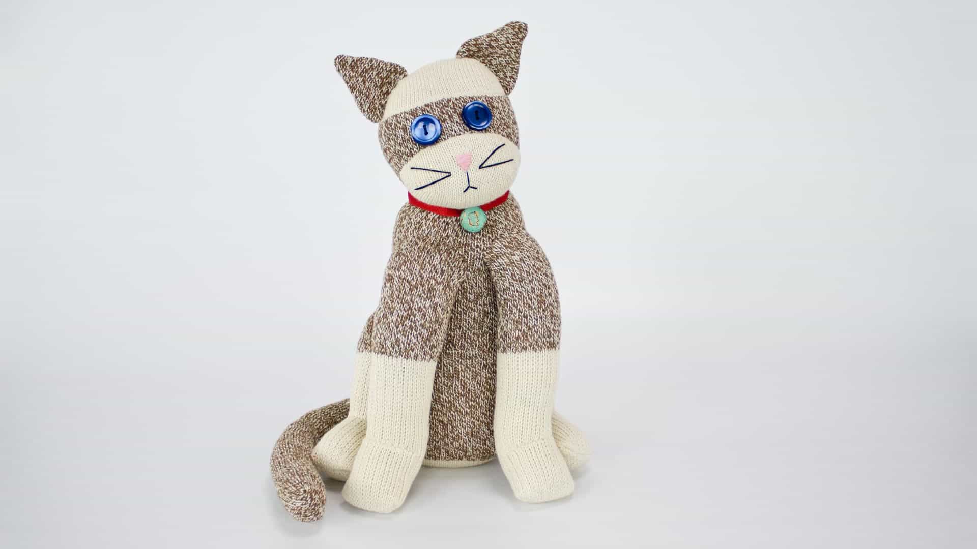 cat stuffed animal made from white and tweed socks