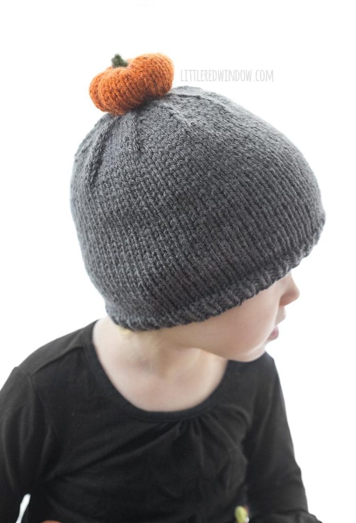 The pumpkin patch hat knitting pattern has a little (adorable) knit pumpkin pom pom on top! It's the perfect fall hat to knit for your baby or toddler!