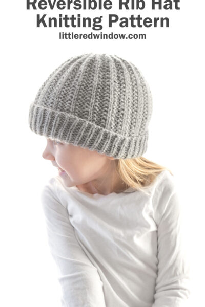 girl in white shirt wearing light gray reversible rib hat and looking off to the left