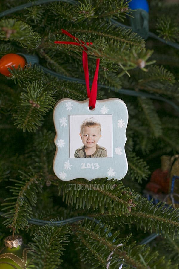 finished ornament hanging on a Christmas tree, this side has little boy's picture and the date