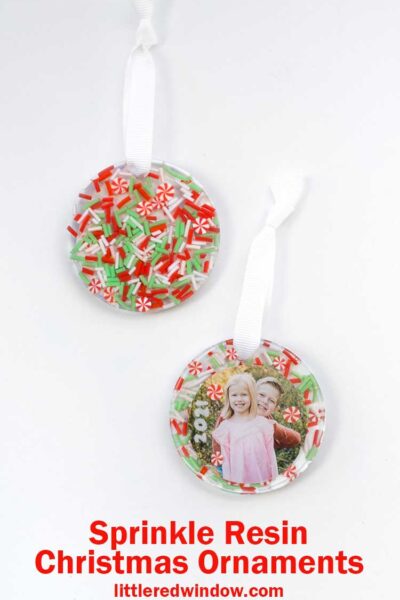 two finished resin christmas ornaments one showing the photo on the front and one showing the sprinkles on the back on a white background
