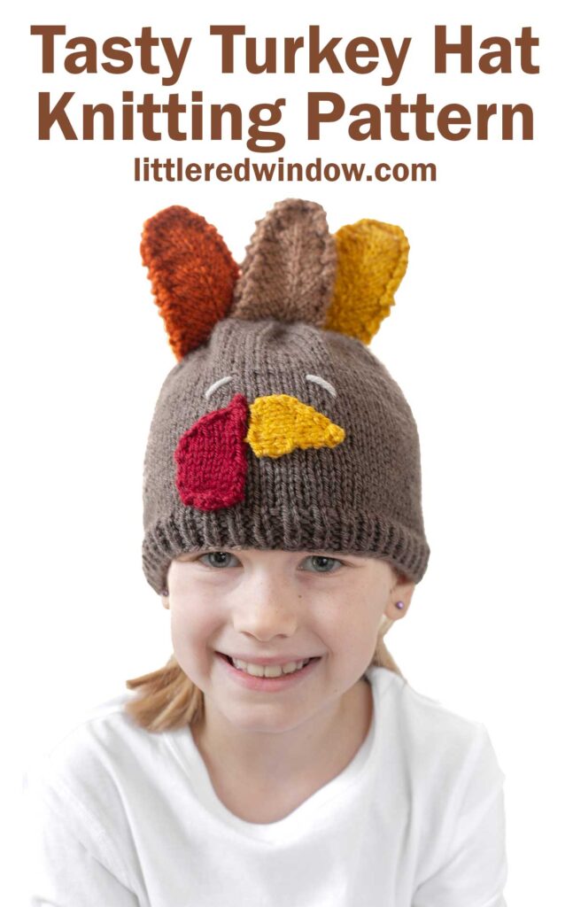 Child wearing a knitted turkey hat fall knitting pattern with colorful knitted feathers on top. The text reads