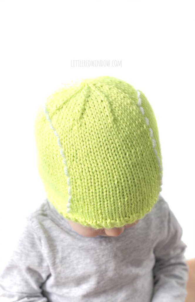 top view of baby wearing green tennis ball hat