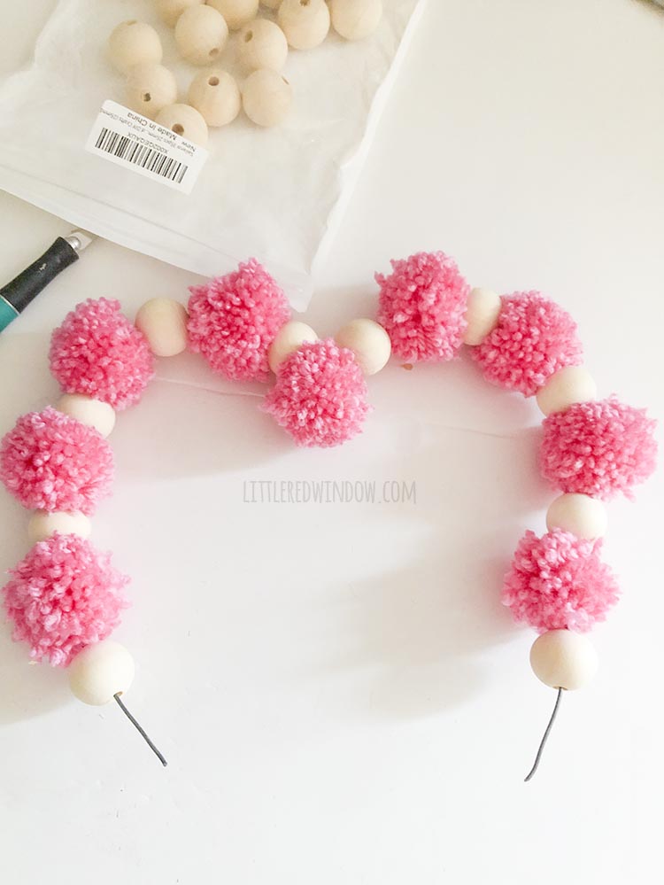 pom pom and wood bead heart shape halfway complete