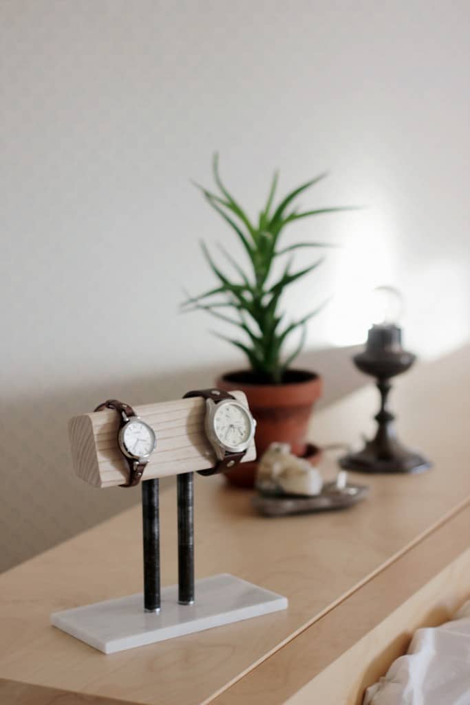 Wood and metal watch holder stand on a dresser top