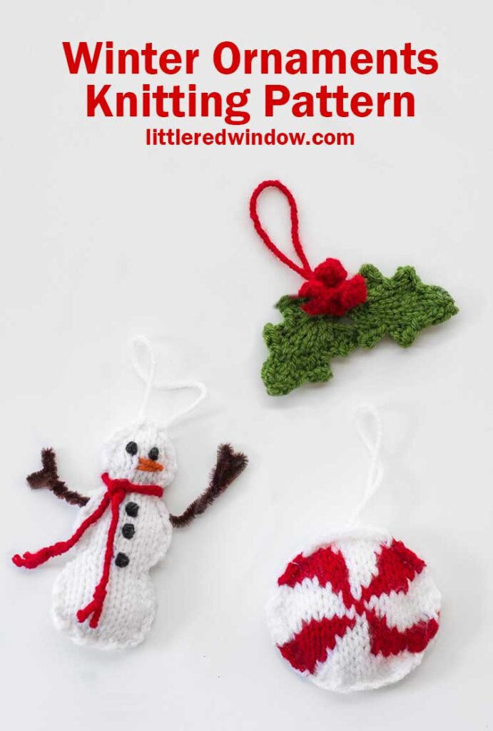 Three knit Christmas tree ornaments in the shape of a snowman a round red and white peppermint candy and a pair of holly leaves with red berries on a white background