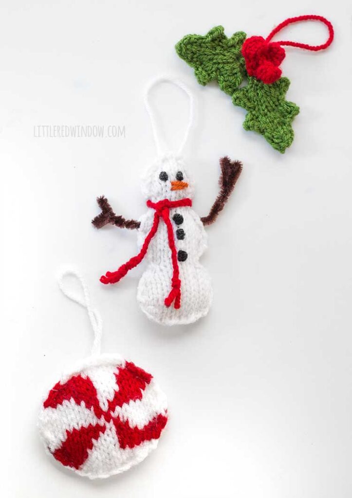 Knit peppermint candy, snowman and holly leaf ornaments on a white background